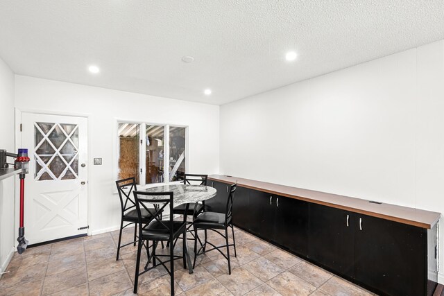 3024 8th Ave S, Great Falls, MT 59405 - dining room with recessed lighting, light stone finish flooring, baseboards, and a textured ceiling