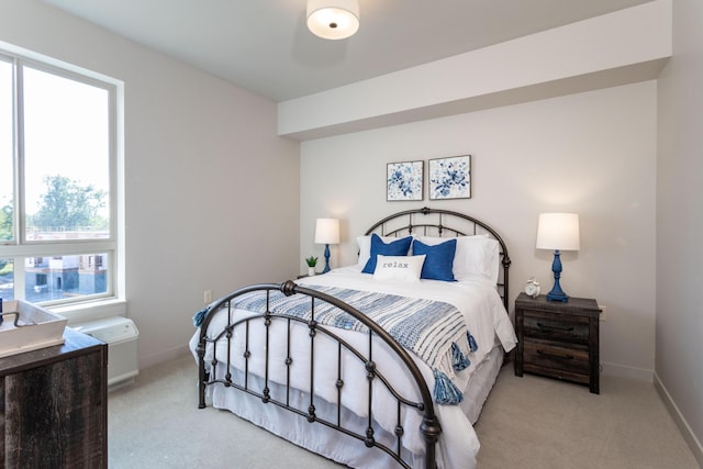 carpeted bedroom featuring baseboards
