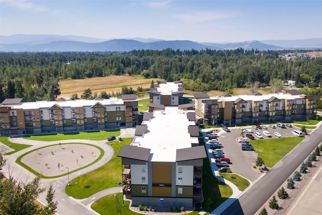 drone / aerial view of mountains and a heavily wooded area