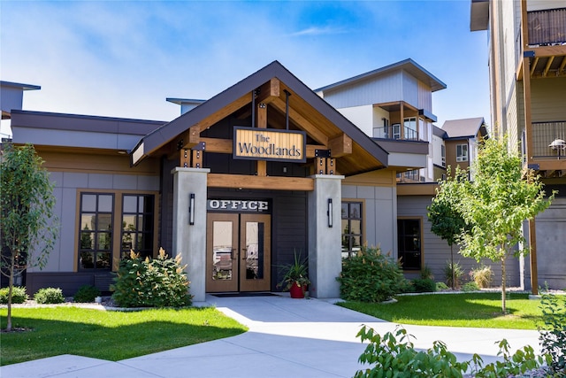 view of front of home with a front lawn and french doors
