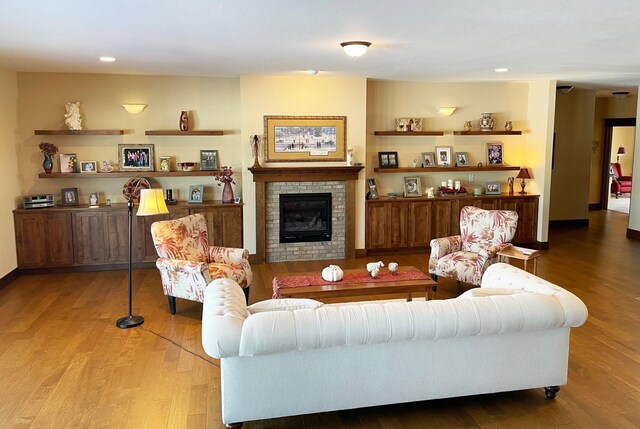 4195 Fox Hollow Dr, Helena, MT 59602 - living area with wood finished floors, a brick fireplace, recessed lighting, and baseboards