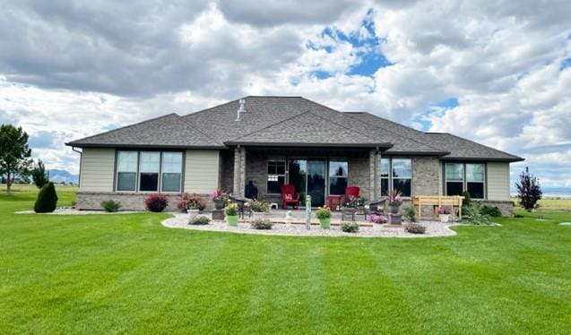 4195 Fox Hollow Dr, Helena, MT 59602 - back of house with a patio area, a lawn, and brick siding
