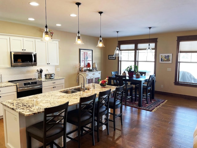 4195 Fox Hollow Dr, Helena, MT 59602 - kitchen with stainless steel appliances, a sink, plenty of natural light, white cabinets, and recessed lighting