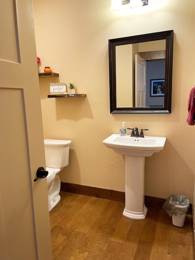 4195 Fox Hollow Dr, Helena, MT 59602 - half bath with wood finished floors, baseboards, and toilet