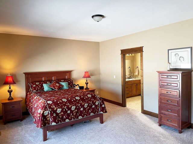 4195 Fox Hollow Dr, Helena, MT 59602 - bedroom with light colored carpet, ensuite bathroom, and baseboards