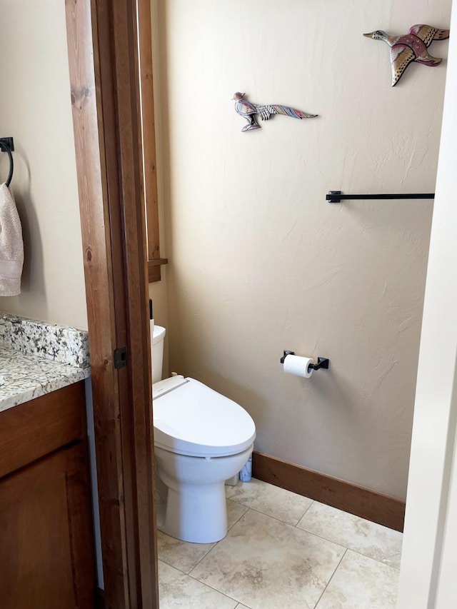 4195 Fox Hollow Dr, Helena, MT 59602 - half bath featuring vanity, toilet, baseboards, and tile patterned flooring