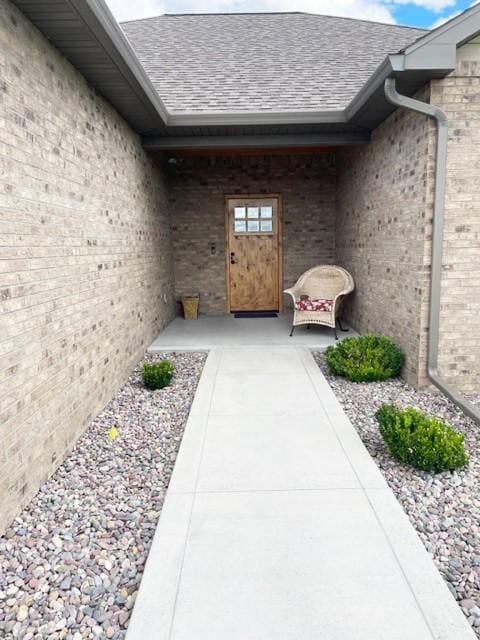 4195 Fox Hollow Dr, Helena, MT 59602 - doorway to property featuring roof with shingles and brick siding