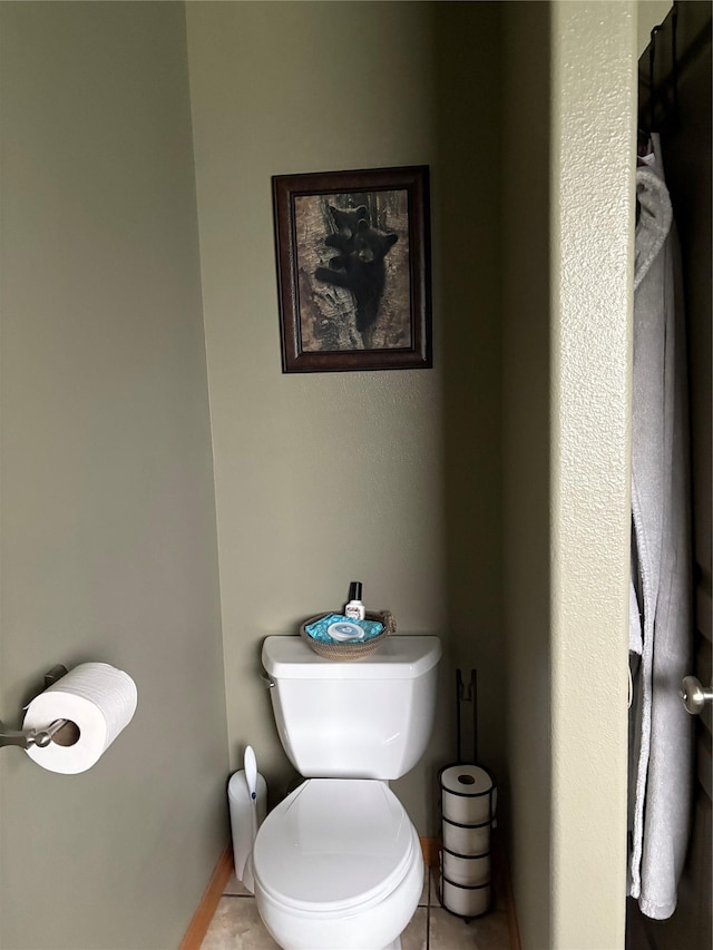 72822 Joes Ln, Arlee, MT 59821 - bathroom featuring tile patterned flooring, toilet, and baseboards