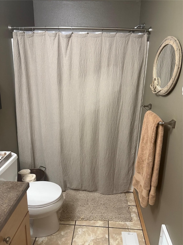 72822 Joes Ln, Arlee, MT 59821 - full bathroom with toilet, vanity, curtained shower, and tile patterned flooring