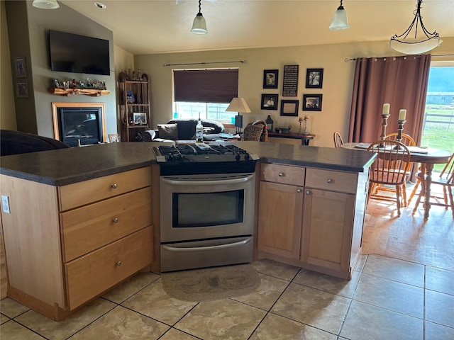 72822 Joes Ln, Arlee, MT 59821 - kitchen with stainless steel gas range oven, healthy amount of natural light, and dark countertops