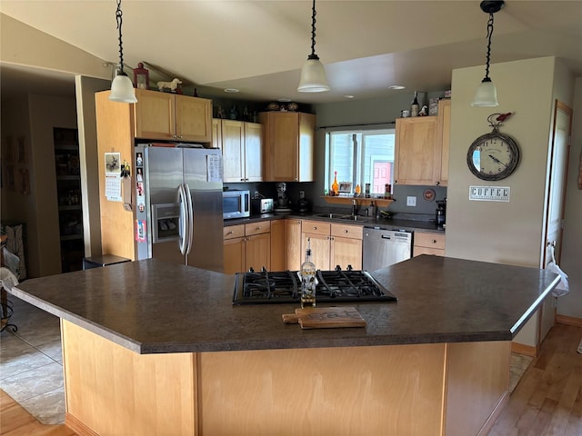 72822 Joes Ln, Arlee, MT 59821 - kitchen with stainless steel appliances, light brown cabinetry, dark countertops, and a sink