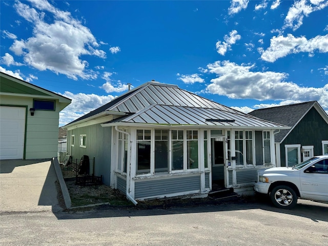 76 Missoula Ave, Butte, MT 59701 - rear view of house with a standing seam roof, a sunroom, and metal roof