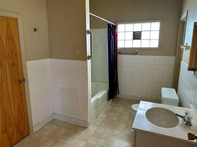 76 Missoula Ave, Butte, MT 59701 - full bathroom with toilet, tile walls, shower / bathtub combination with curtain, and vanity