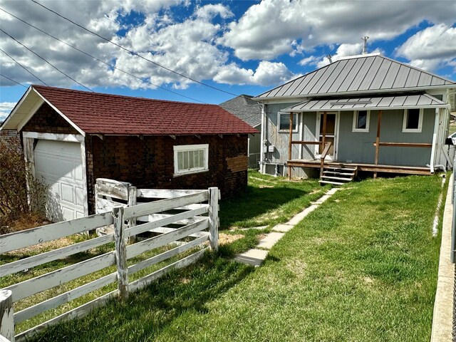 76 Missoula Ave, Butte, MT 59701 - view of front of home featuring a standing seam roof, metal roof, a detached garage, and an outbuilding