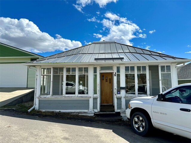 76 Missoula Ave, Butte, MT 59701 - view of front of house with a sunroom, a standing seam roof, metal roof, and entry steps