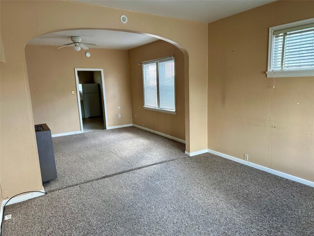 76 Missoula Ave, Butte, MT 59701 - empty room with ceiling fan, carpet flooring, arched walkways, and baseboards