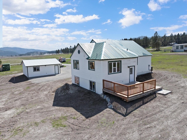 149 Vonderheide Ln, Kalispell, MT 59901 - back of house featuring a deck with mountain view and a metal roof