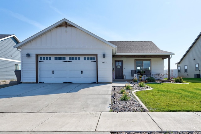 single story home with a front yard, a porch, driveway, an attached garage, and board and batten siding