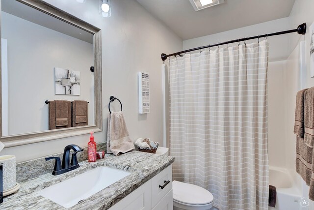 2841 Ashley Ave, East Helena, MT 59635 - full bathroom featuring toilet, vanity, and shower / bath combo with shower curtain