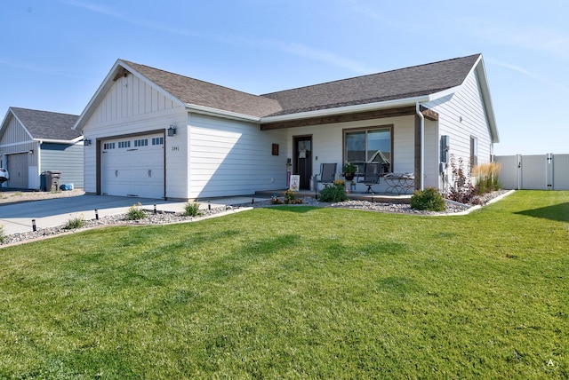 2841 Ashley Ave, East Helena, MT 59635 - view of front of home with a garage, covered porch, board and batten siding, a gate, and concrete driveway