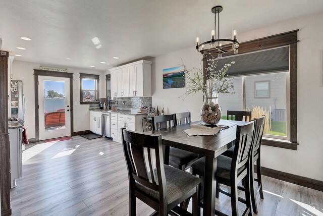 2841 Ashley Ave, East Helena, MT 59635 - dining room featuring a chandelier, baseboards, light wood-style floors, and recessed lighting