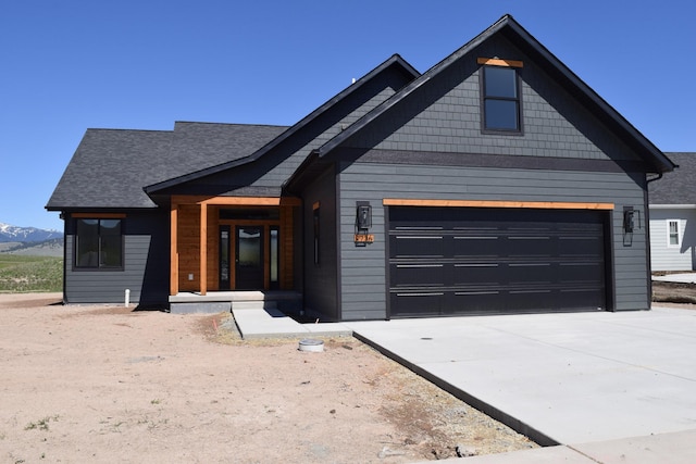 2736 Paniolo Pl, Missoula, MT 59808 - view of front of property featuring driveway, a mountain view, and roof with shingles