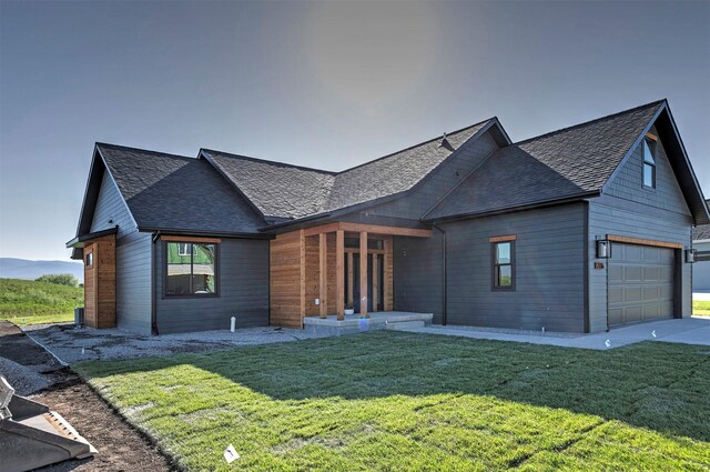 2736 Paniolo Pl, Missoula, MT 59808 - view of front of home featuring a garage, a front yard, and a shingled roof