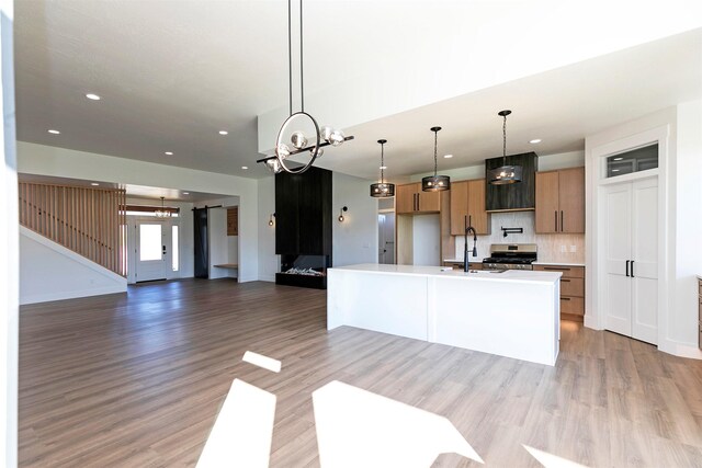 2736 Paniolo Pl, Missoula, MT 59808 - kitchen featuring stainless steel stove, a chandelier, a sink, tasteful backsplash, and recessed lighting