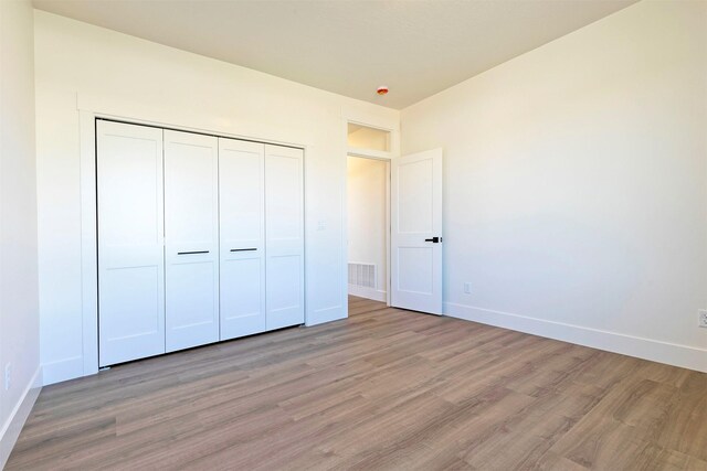 2736 Paniolo Pl, Missoula, MT 59808 - unfurnished bedroom featuring light wood-style flooring and baseboards