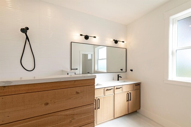 2736 Paniolo Pl, Missoula, MT 59808 - full bathroom featuring double vanity, baseboards, and wood finished floors