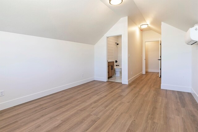 2736 Paniolo Pl, Missoula, MT 59808 - additional living space with light wood-style floors, lofted ceiling, baseboards, and a wall mounted AC