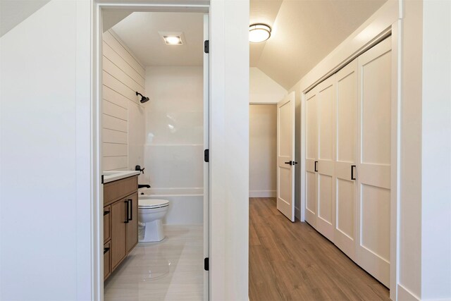 2736 Paniolo Pl, Missoula, MT 59808 - bathroom with vanity, toilet, bathtub / shower combination, lofted ceiling, and wood finished floors