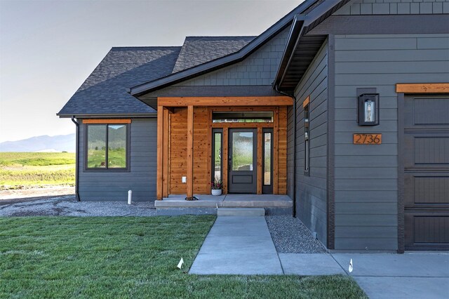 2736 Paniolo Pl, Missoula, MT 59808 - property entrance featuring a mountain view, a yard, and a shingled roof