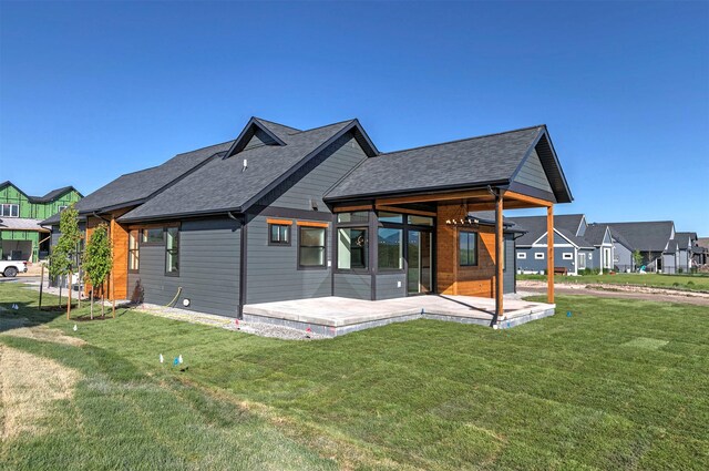 2736 Paniolo Pl, Missoula, MT 59808 - rear view of property with a lawn, a patio, and a shingled roof