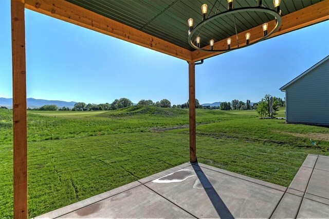 2736 Paniolo Pl, Missoula, MT 59808 - view of green lawn featuring a rural view, a mountain view, and a patio