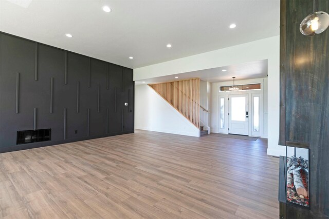 2736 Paniolo Pl, Missoula, MT 59808 - unfurnished living room with stairway, light wood finished floors, recessed lighting, and baseboards