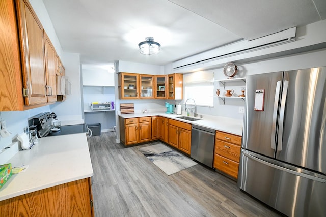 1536 Meadowlark Dr Unit 10B, Great Falls, MT 59404 - kitchen featuring appliances with stainless steel finishes, brown cabinets, light wood finished floors, and light countertops