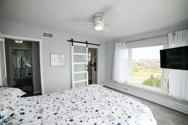 1536 Meadowlark Dr Unit 10B, Great Falls, MT 59404 - bedroom featuring a barn door, baseboard heating, carpet floors, and a ceiling fan