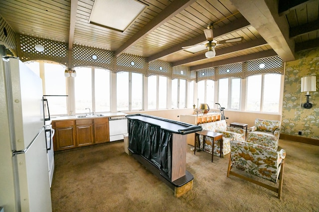 1536 Meadowlark Dr Unit 10B, Great Falls, MT 59404 - kitchen with white appliances, brown cabinetry, dark colored carpet, wallpapered walls, and ceiling fan