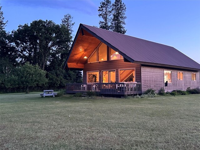 200 Weaver Ln, Kalispell, MT 59901 - rear view of house featuring a lawn, a deck, and metal roof