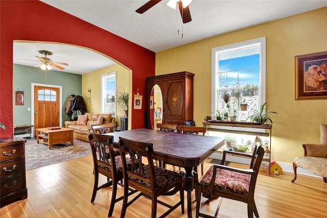 500 34th St NW, Great Falls, MT 59404 - dining room with ceiling fan, light wood-type flooring, and arched walkways