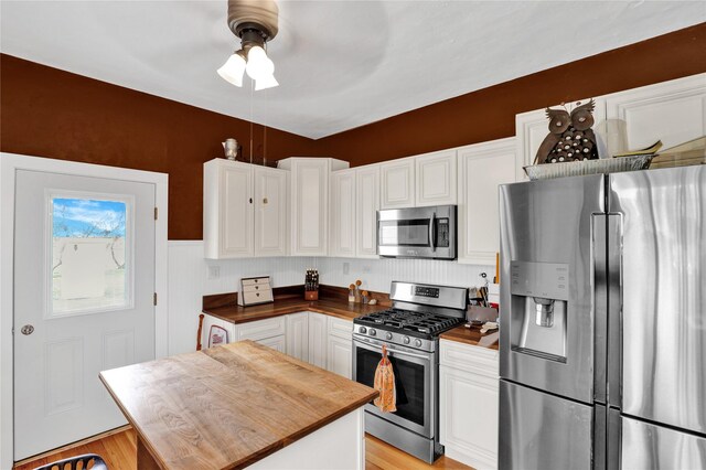 500 34th St NW, Great Falls, MT 59404 - kitchen featuring appliances with stainless steel finishes, butcher block counters, and white cabinets