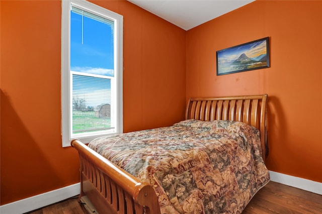 500 34th St NW, Great Falls, MT 59404 - bedroom with baseboards and dark wood-style flooring