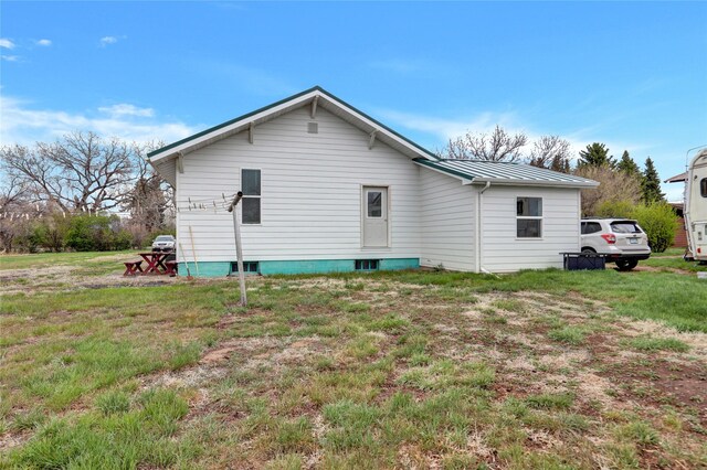 500 34th St NW, Great Falls, MT 59404 - rear view of property featuring a standing seam roof, metal roof, and a lawn
