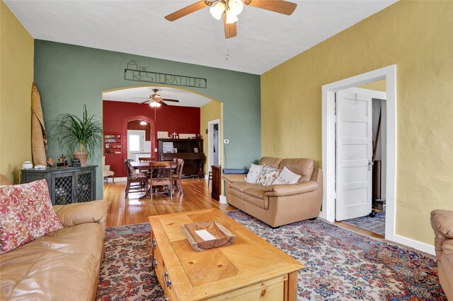 500 34th St NW, Great Falls, MT 59404 - living area featuring arched walkways, a ceiling fan, and wood finished floors