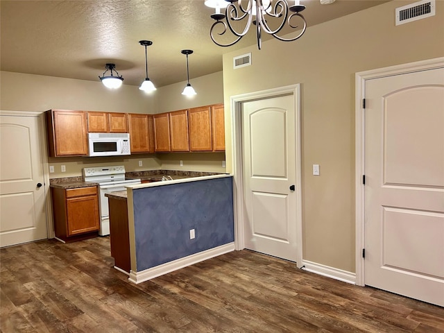 2905 Oshaughnesy St Unit 104, Missoula, MT 59808 - kitchen with white appliances, a chandelier, dark wood-type flooring, brown cabinets, and a textured ceiling