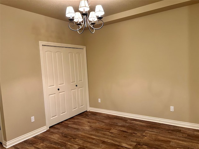 2905 Oshaughnesy St Unit 104, Missoula, MT 59808 - unfurnished dining area with dark wood-style flooring, a chandelier, and baseboards
