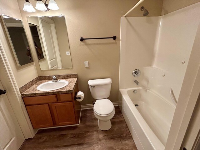 2905 Oshaughnesy St Unit 104, Missoula, MT 59808 - full bathroom with  shower combination, toilet, wood finished floors, vanity, and baseboards