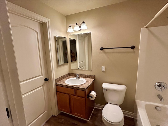 2905 Oshaughnesy St Unit 104, Missoula, MT 59808 - bathroom featuring toilet, vanity, tub / shower combination, and baseboards
