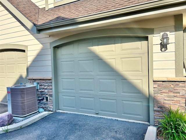 2905 Oshaughnesy St Unit 104, Missoula, MT 59808 - garage featuring cooling unit and driveway